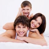 smiling family on bed